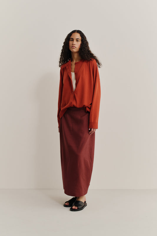 Women's knit cardigan, 100% merino wool, rust, with a deep V-neck and mock underlayer.