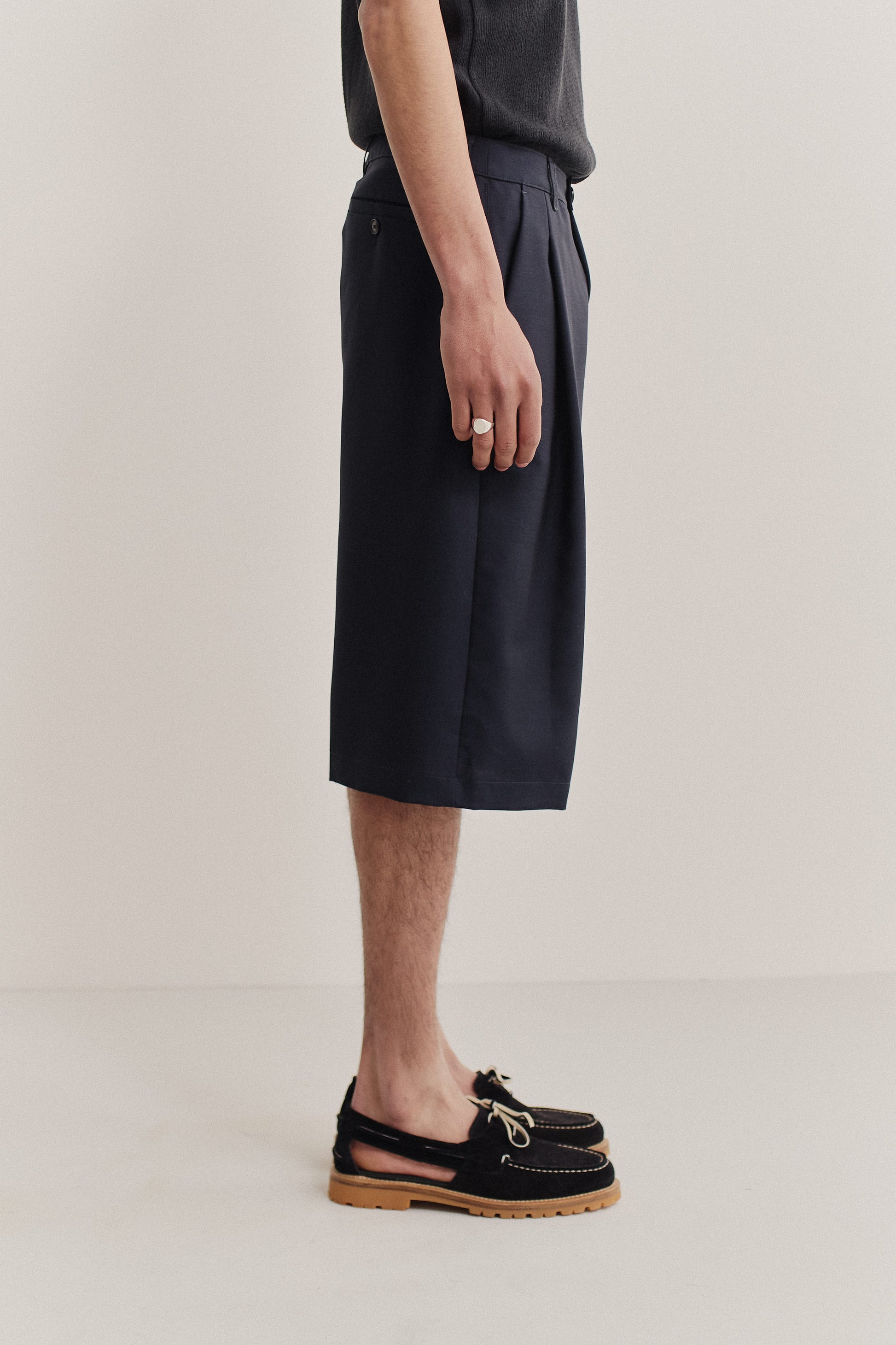 Unisex shorts, dark navy virgin wool, knee-length, relaxed fit, wide leg, single pleat.