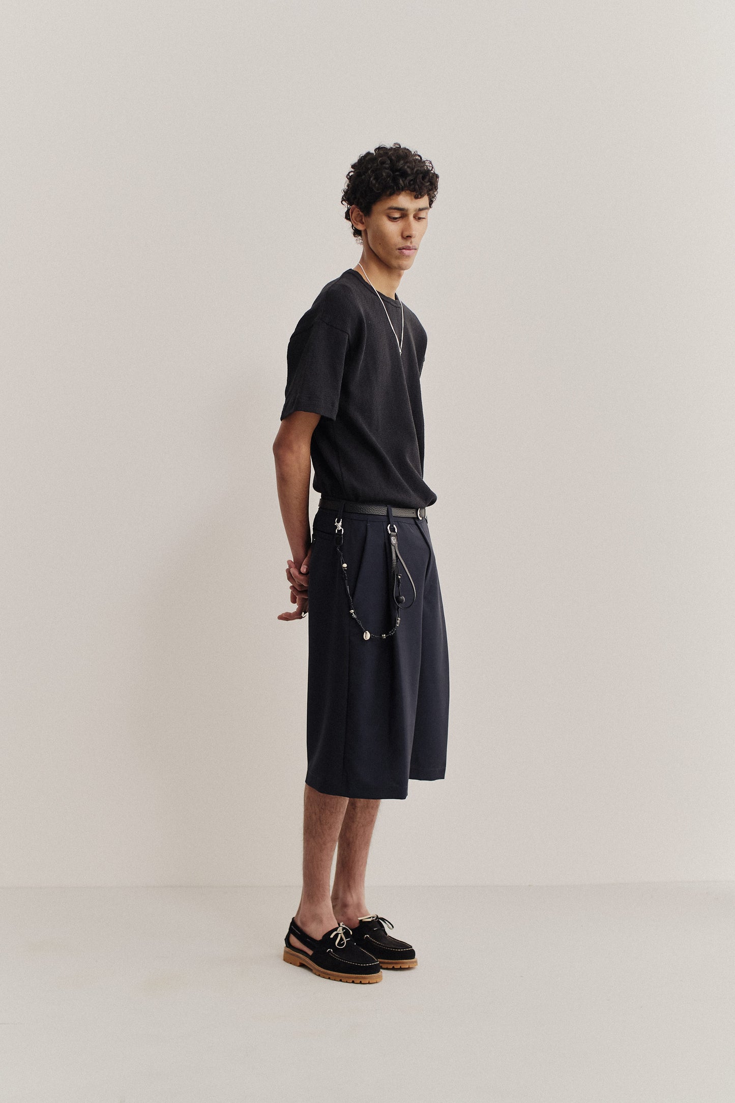 Unisex shorts, virgin wool, dark navy, knee-length, relaxed fit, wide leg, single pleat, slanted pockets.