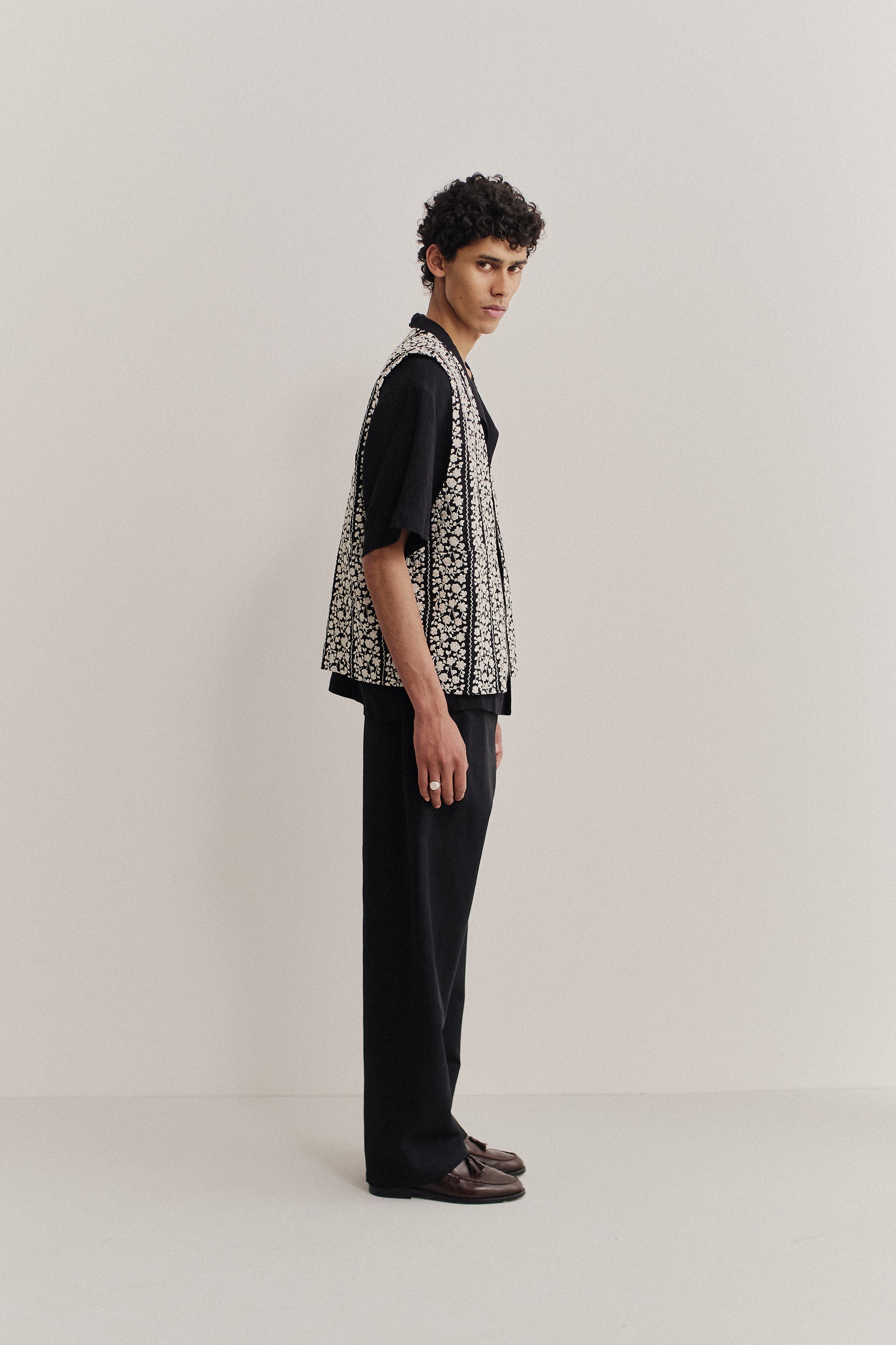 Men's outerwear vest, black cotton with embroidered white flower blocks, metal zipper, oversized fit.