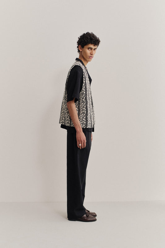 Men's outerwear vest, black cotton with embroidered white flower blocks, metal zipper, oversized fit.