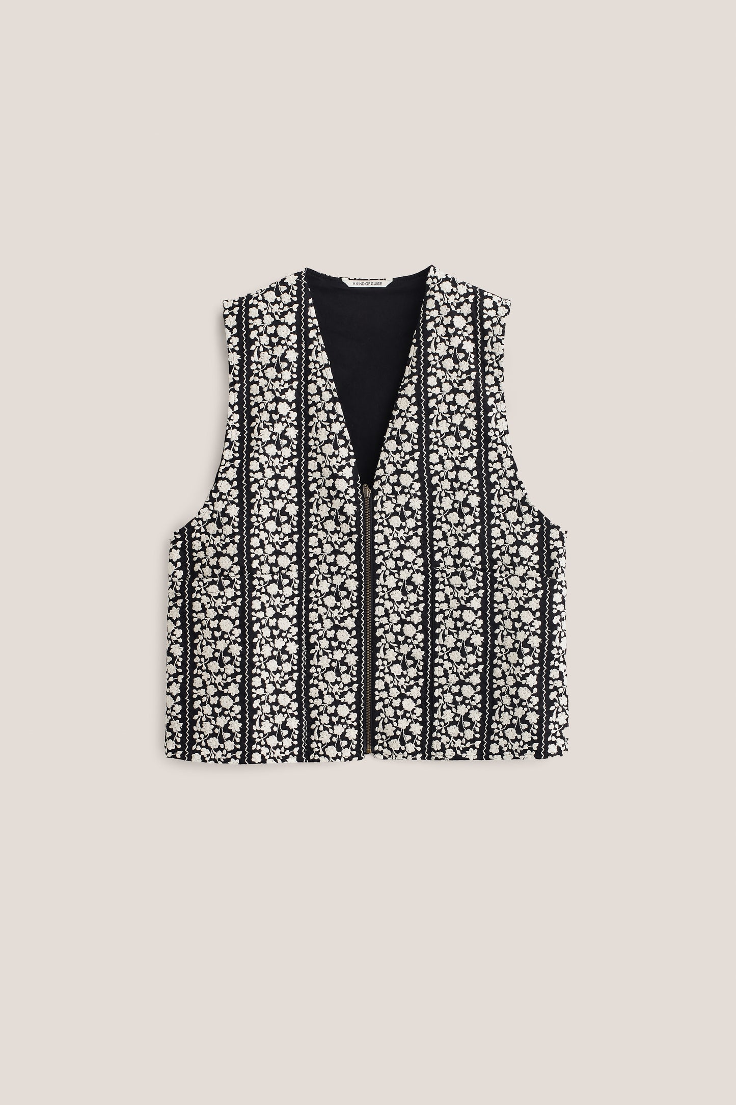 Women's outerwear vest, black cotton with white embroidered floral blocks and a metal zipper.