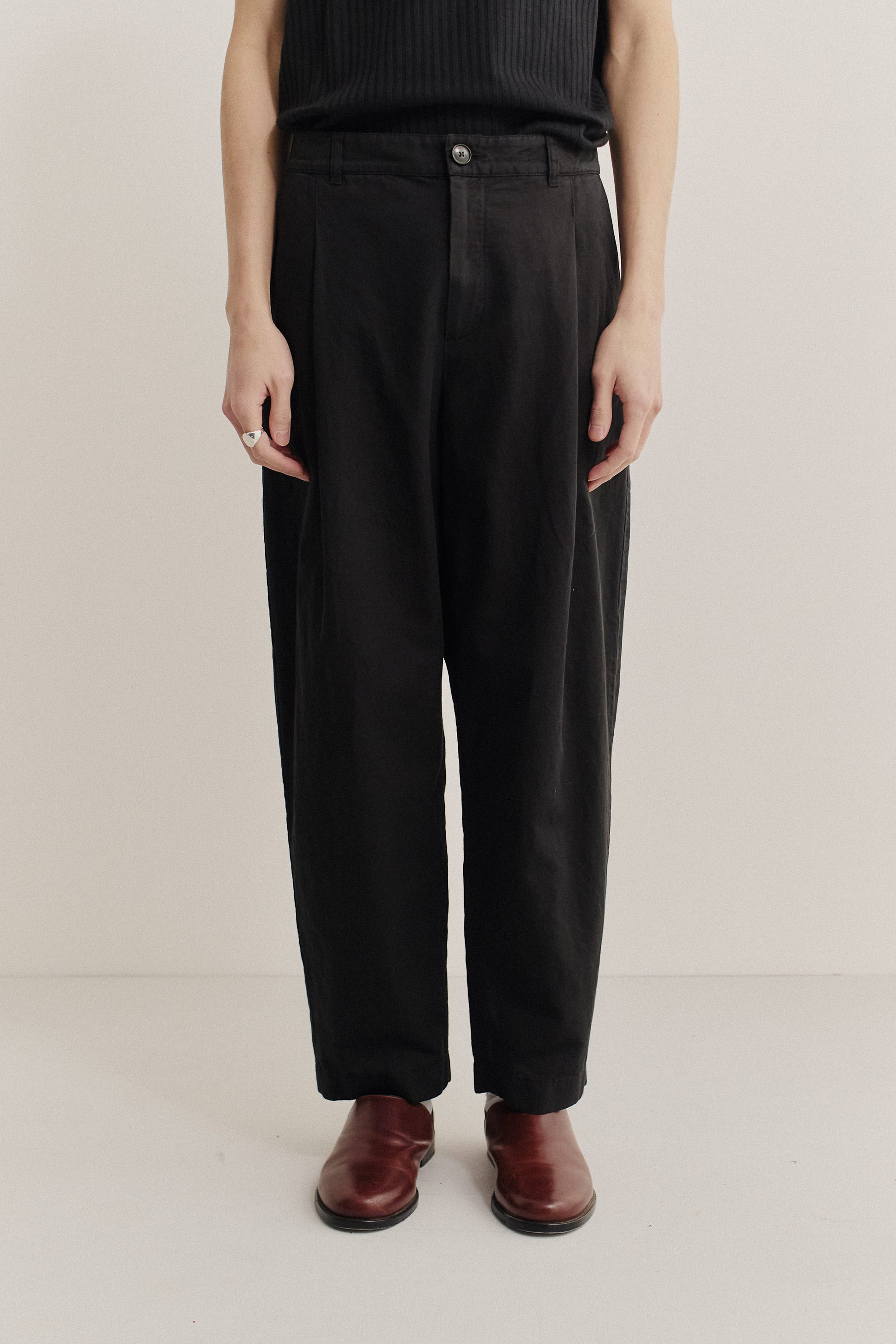 Men's long-pants, linen and cotton blend, garment-dyed black, with single front pleats and tapered leg.