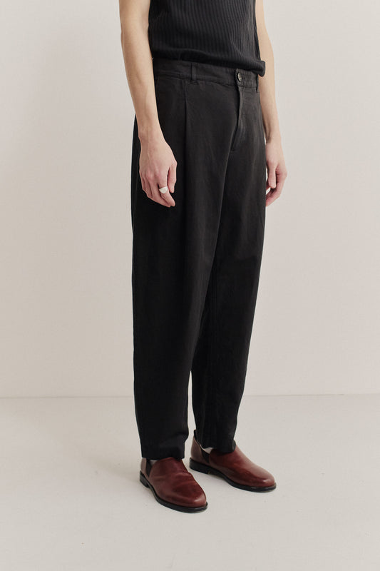 Men's long-pants, linen and cotton blend, garment-dyed black, with single front pleat and tapered leg.