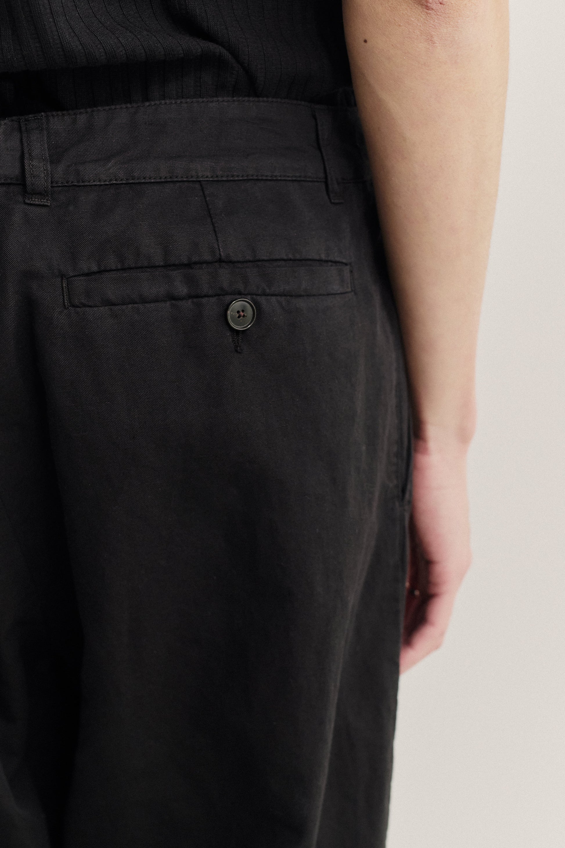Men's long-pants, linen and cotton blend, garment-dyed black, with a single back button pocket.