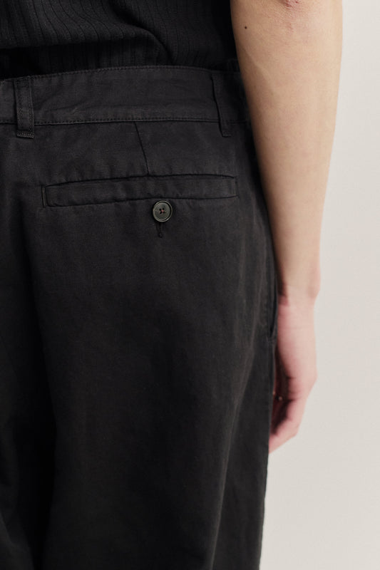 Men's long-pants, linen and cotton blend, garment-dyed black, with a single back button pocket.