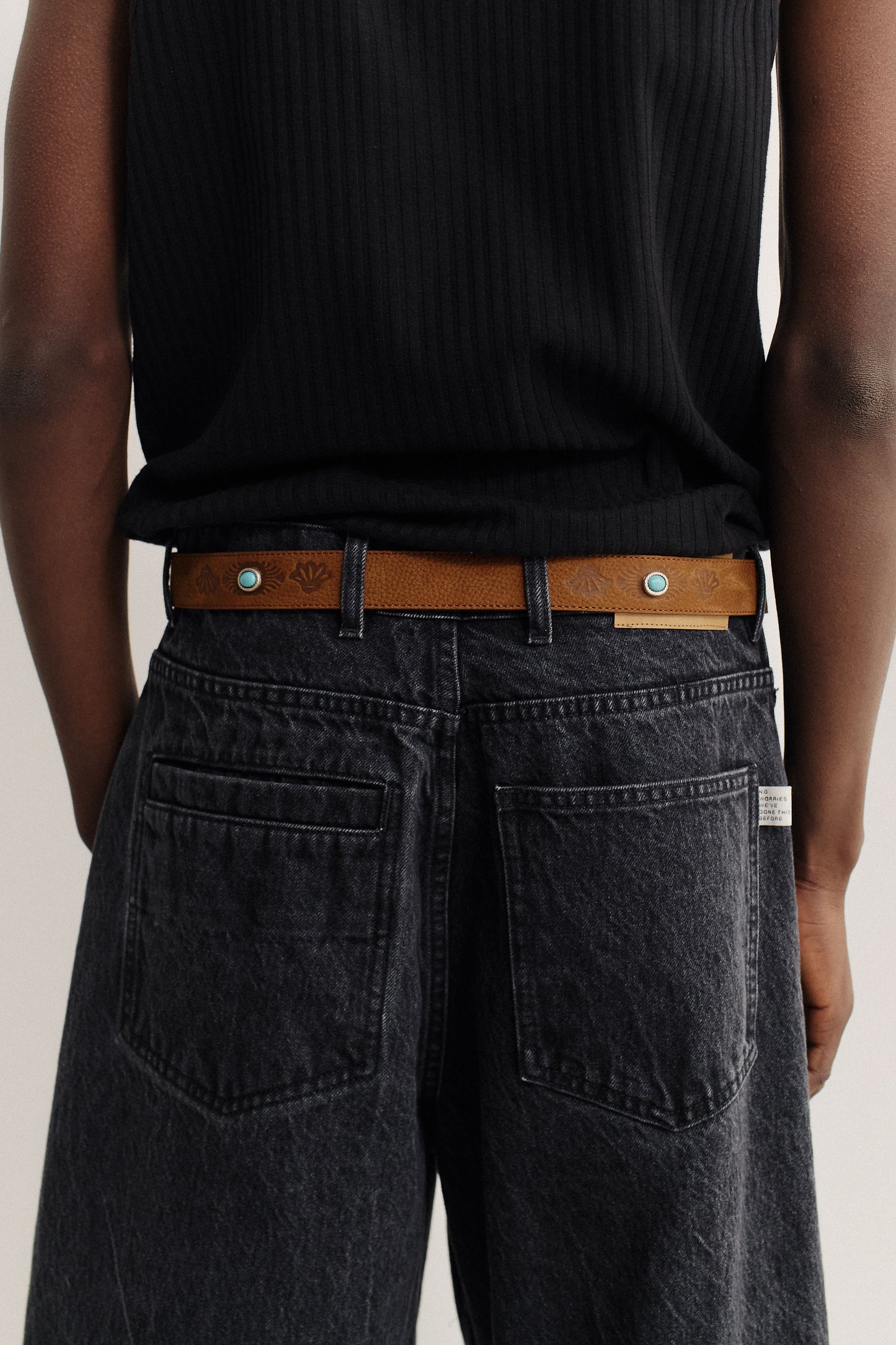 Men's accessories belt, brown nubuck leather with engraved design and turquoise studs.