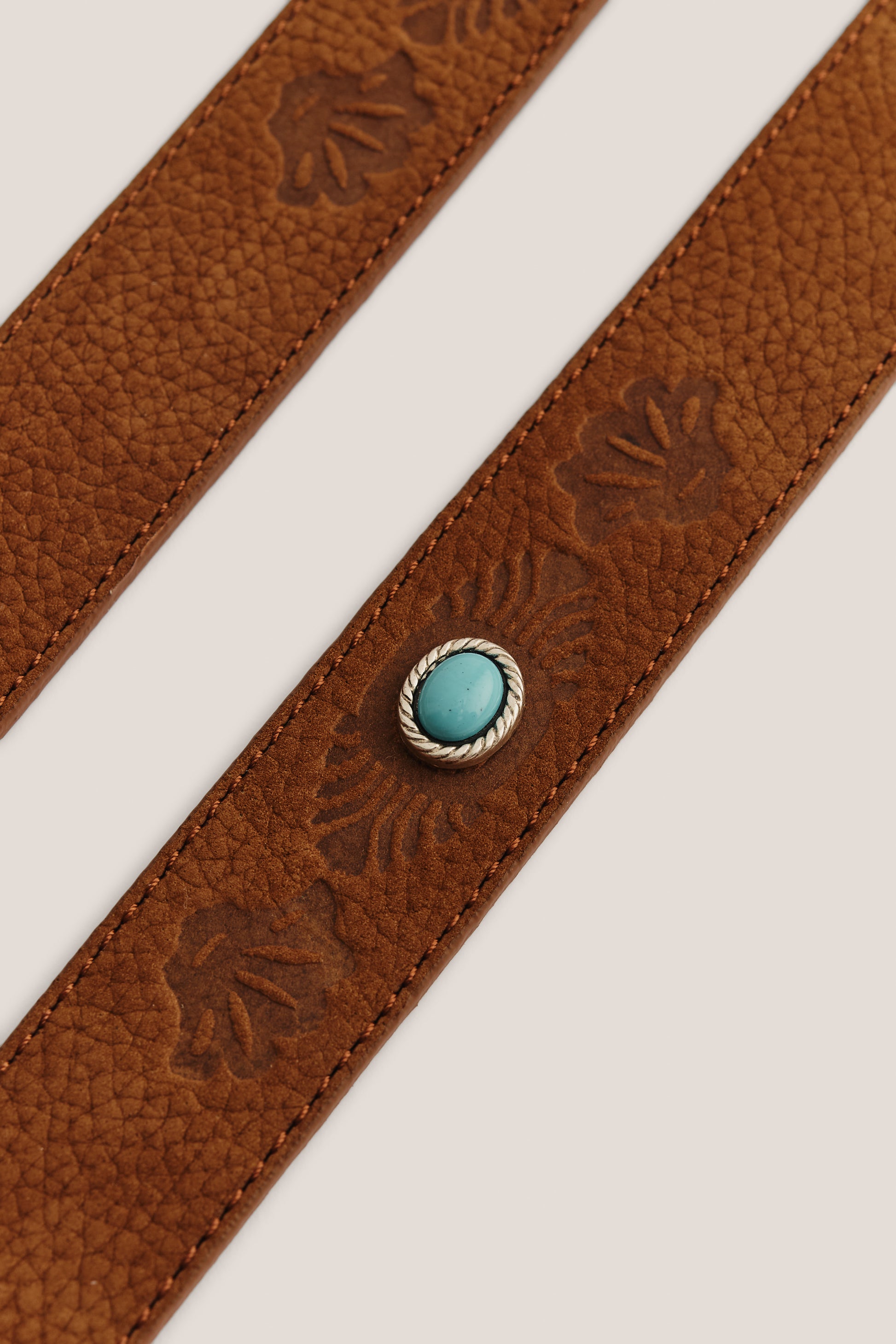Women's accessories belt, brown nubuck leather with embossed floral pattern and turquoise stone buckle.