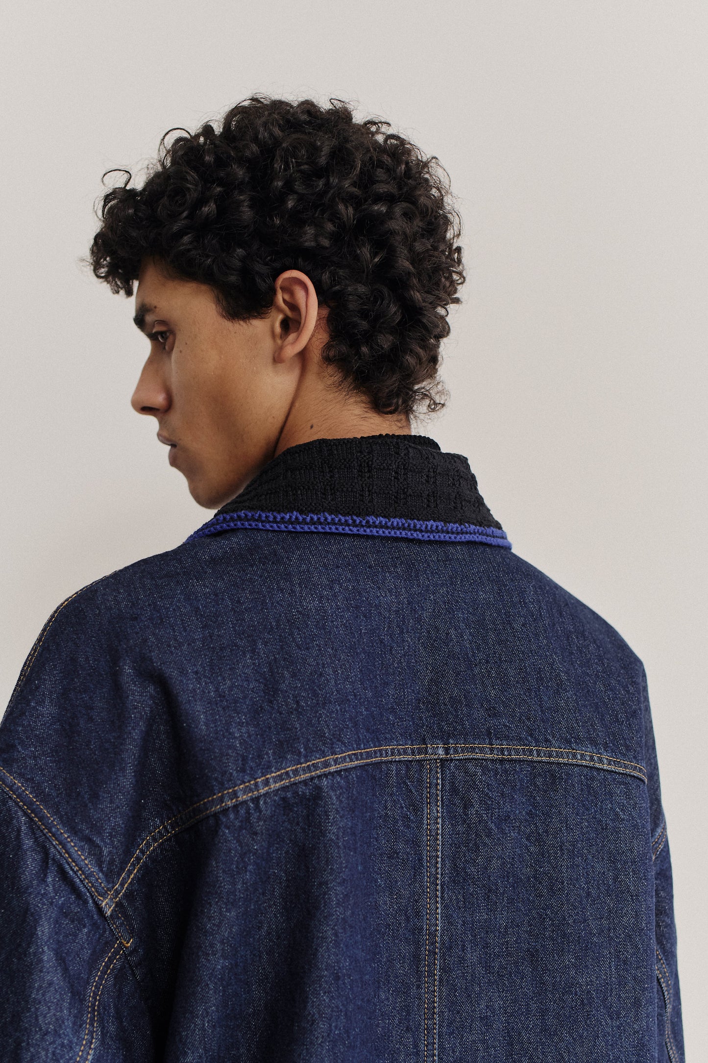 Men's outerwear denim jacket, oversized fit, vintage blue, knitted collar detail.