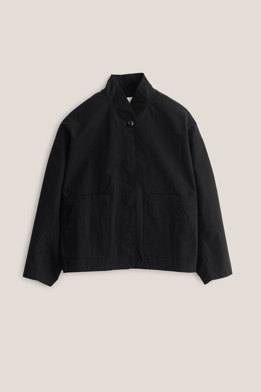 Women's outerwear jacket, black water-repellent cotton blend, with stand collar and front patch pockets.