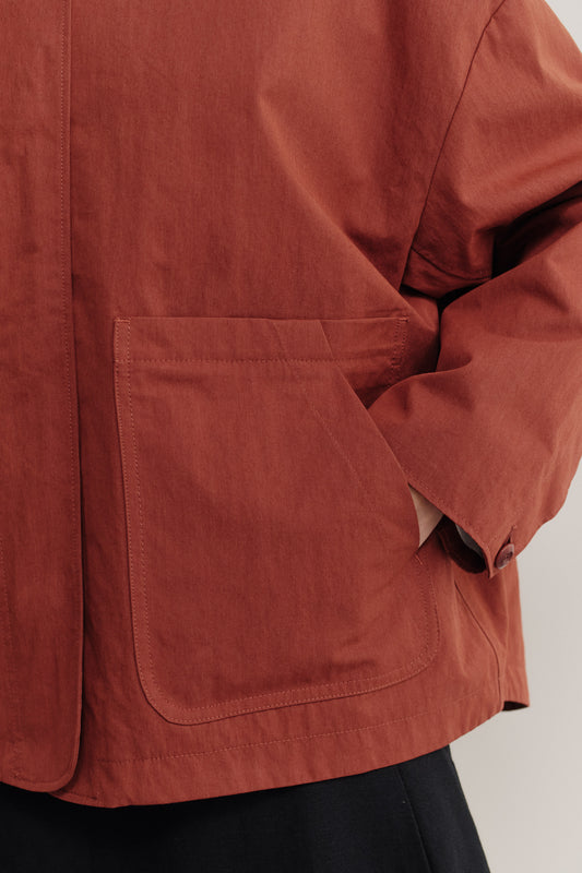 Women's outerwear jacket, rust cotton blend, with a wide cut and front patch pocket.