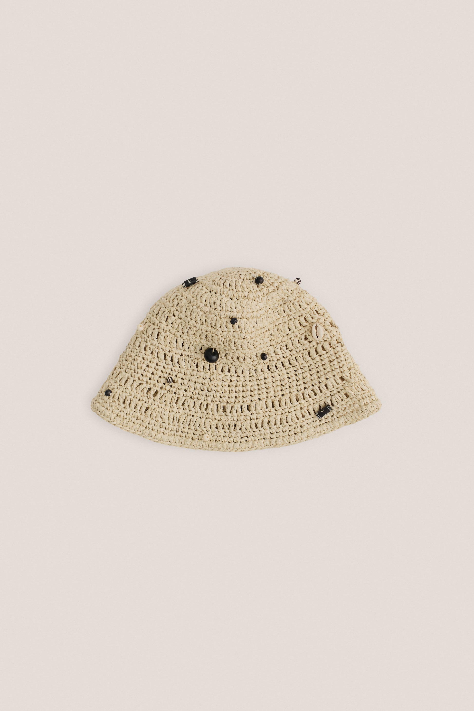 Unisex accessories bucket hat, crocheted Italian viscose-linen blend, natural raffia look, decorated with mussels and wooden beads, light beige.