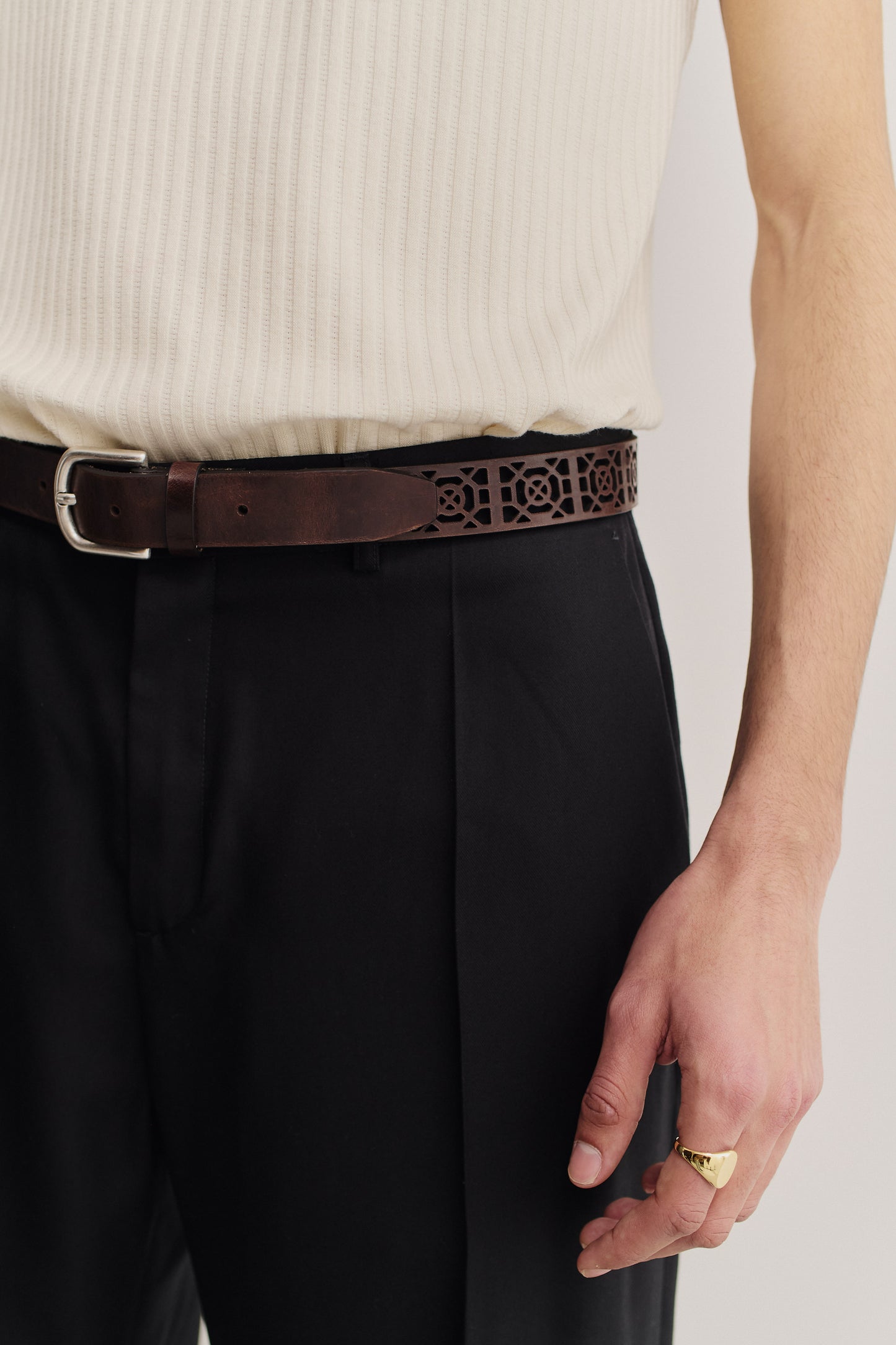 Men's accessories belt, mahogany calf leather with graphical cut-out and antique silver buckle.