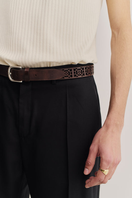 Men's accessories belt, mahogany calf leather with graphical cut-out and antique silver buckle.
