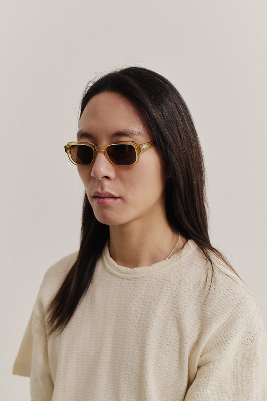 Women's accessories sunglasses, transparent amber acetate, rectangular frame with dark Carl Zeiss lenses.