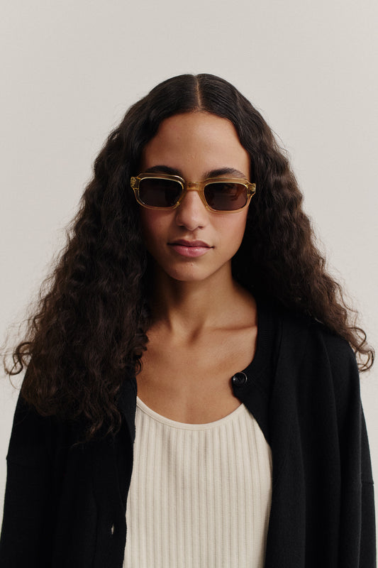 Women's accessories sunglasses, acetate, transparent olive green, rectangular frame with dark lenses.