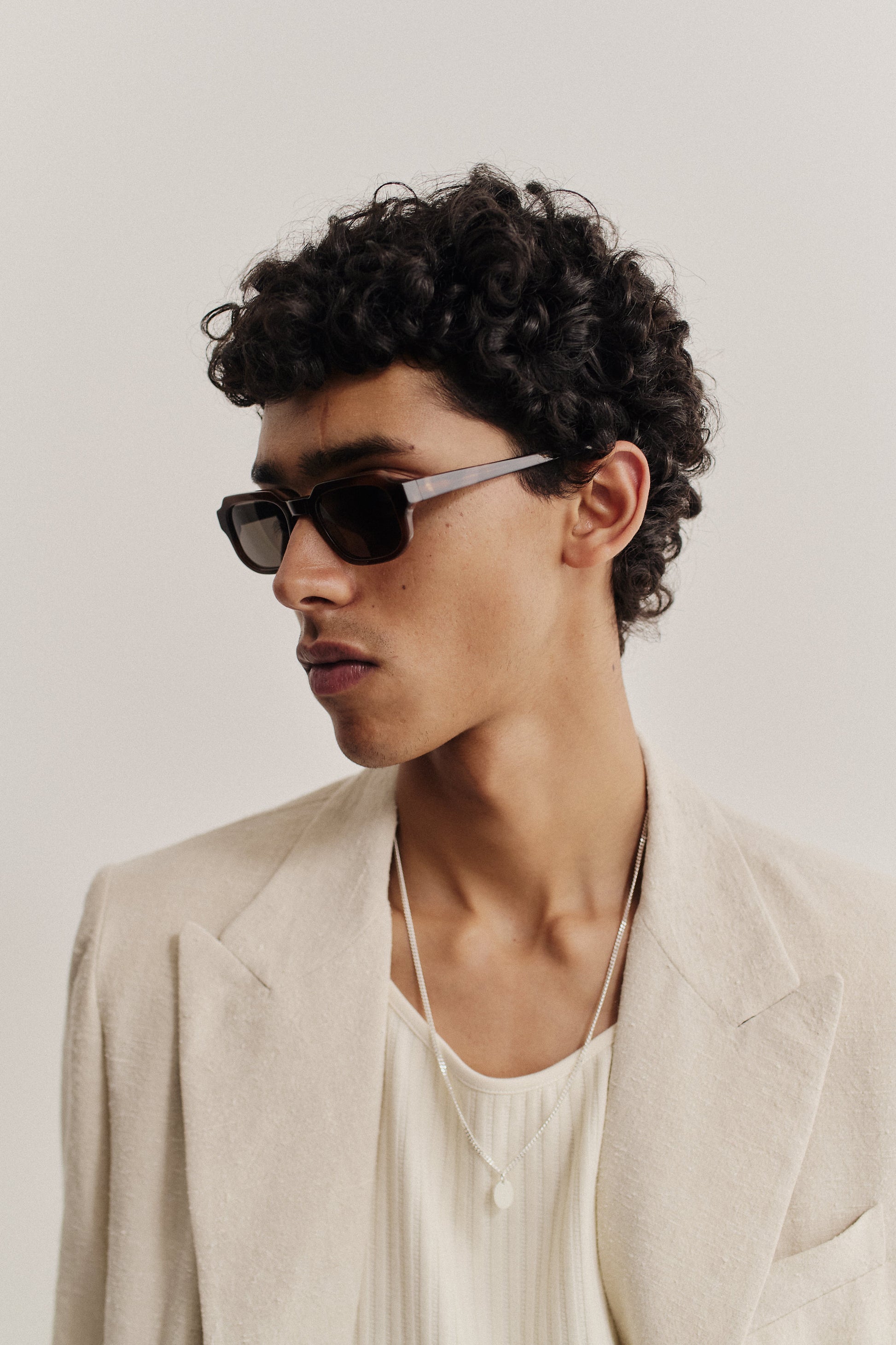Men's accessories, rectangular acetate sunglasses with dark lenses and a beige frame.
