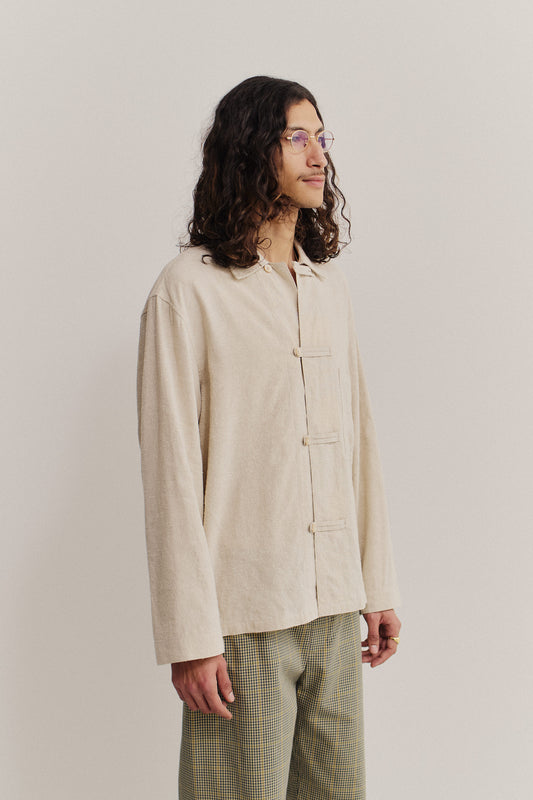 Men's long-sleeved overshirt, linen-silk blend, natural textured, undyed beige, with frog button fastening and patch pocket.