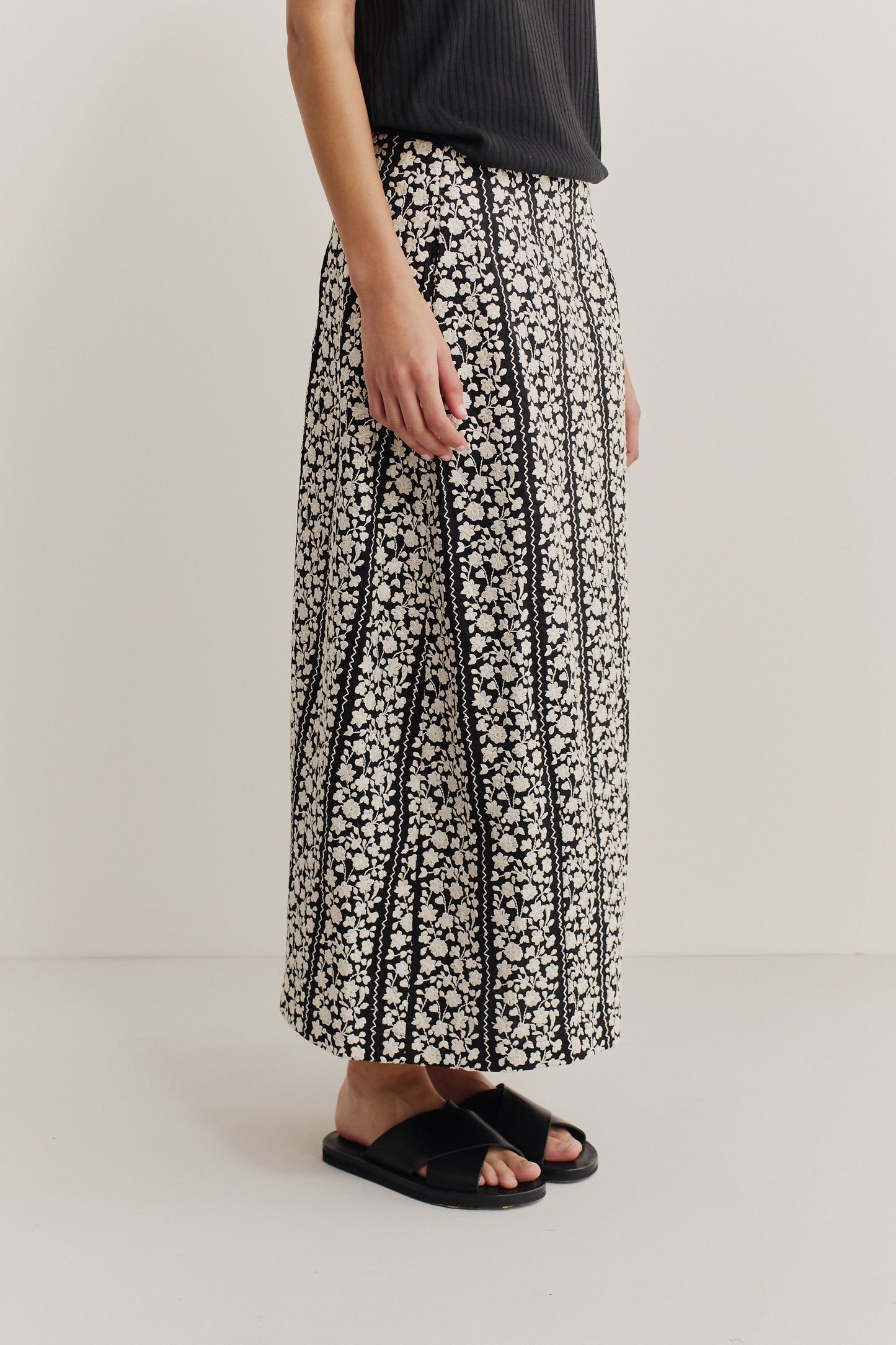 Women's skirt, midi-length, 100% cotton, black with white embroidered floral blocks, o-shaped silhouette.