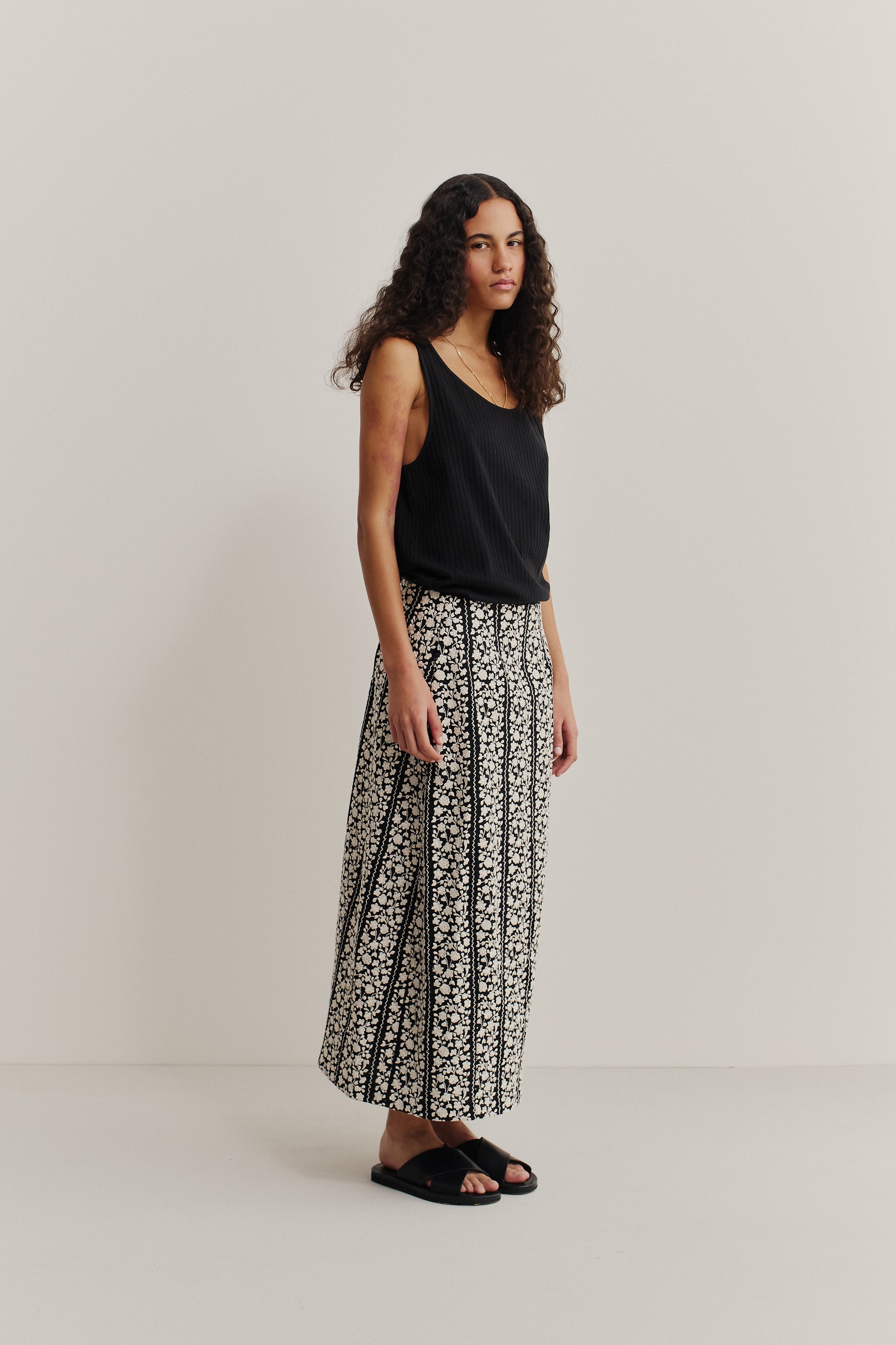 Women's skirt, midi-length, cotton, black with white embroidered flower blocks, o-shaped silhouette.