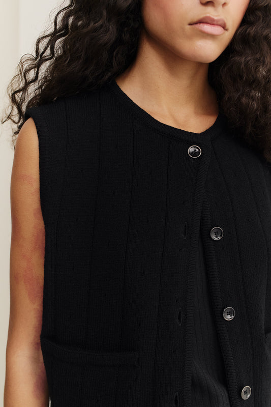 Women's knit vest, black 100% merino wool, ajour knit pattern, button-front, ribbed trim.