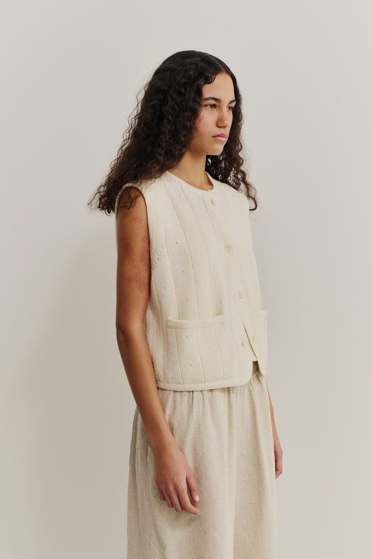 Women's knit vest, 100% merino wool, ajour knit pattern, cream, cropped, with front pockets and buttons.
