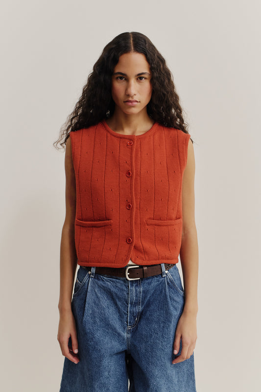 Women's knit vest, 100% merino wool, ajour knit, rust orange, button-front, with pockets.