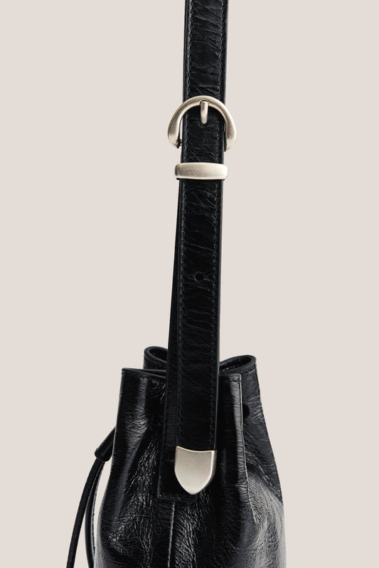 Women's accessories mini round bucket bag, black lwg-certified calf leather with silver buckle.
