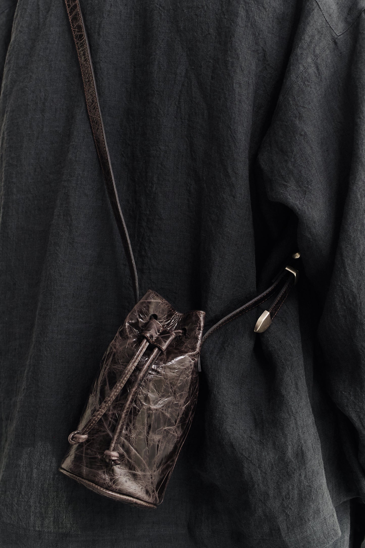 Women's accessories mini round bucket bag, Ndogo Bag, in dark brown lwg-certified calf leather with drawstring closure.