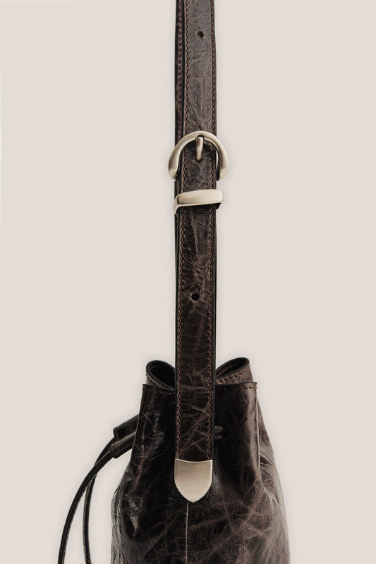 Women's accessories mini round bucket bag, dark brown lwg-certified calf leather with silver buckle.