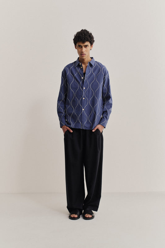 Men's long-sleeved shirt, 100% cotton, soft blue with embroidered navy wavy pattern and white contrast stitching.