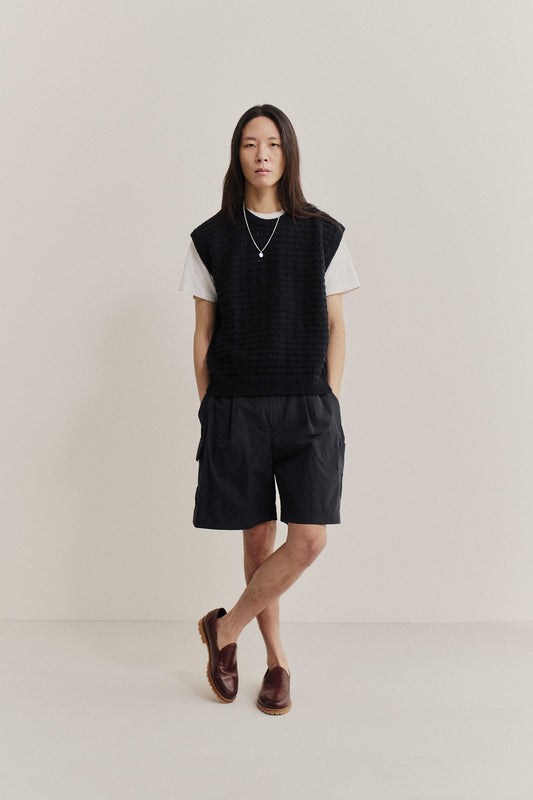 Men's shorts, recycled nylon cotton blend, black, relaxed fit, elastic waist, patch pockets.