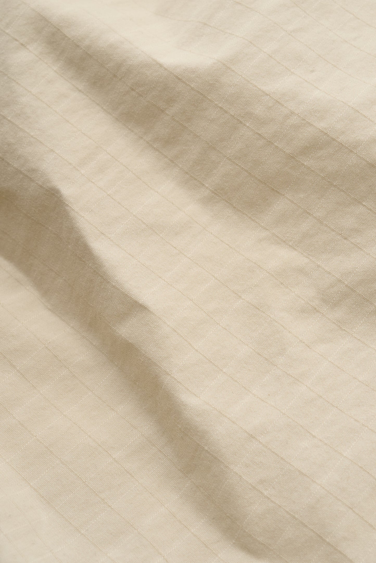 Men's shorts, cotton blend ripstop, waxed finish, beige, with subtle striped texture.