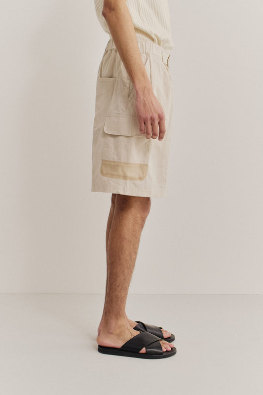 Men's shorts, cotton blend ripstop, waxed finish, beige, with patch pockets and mesh details.