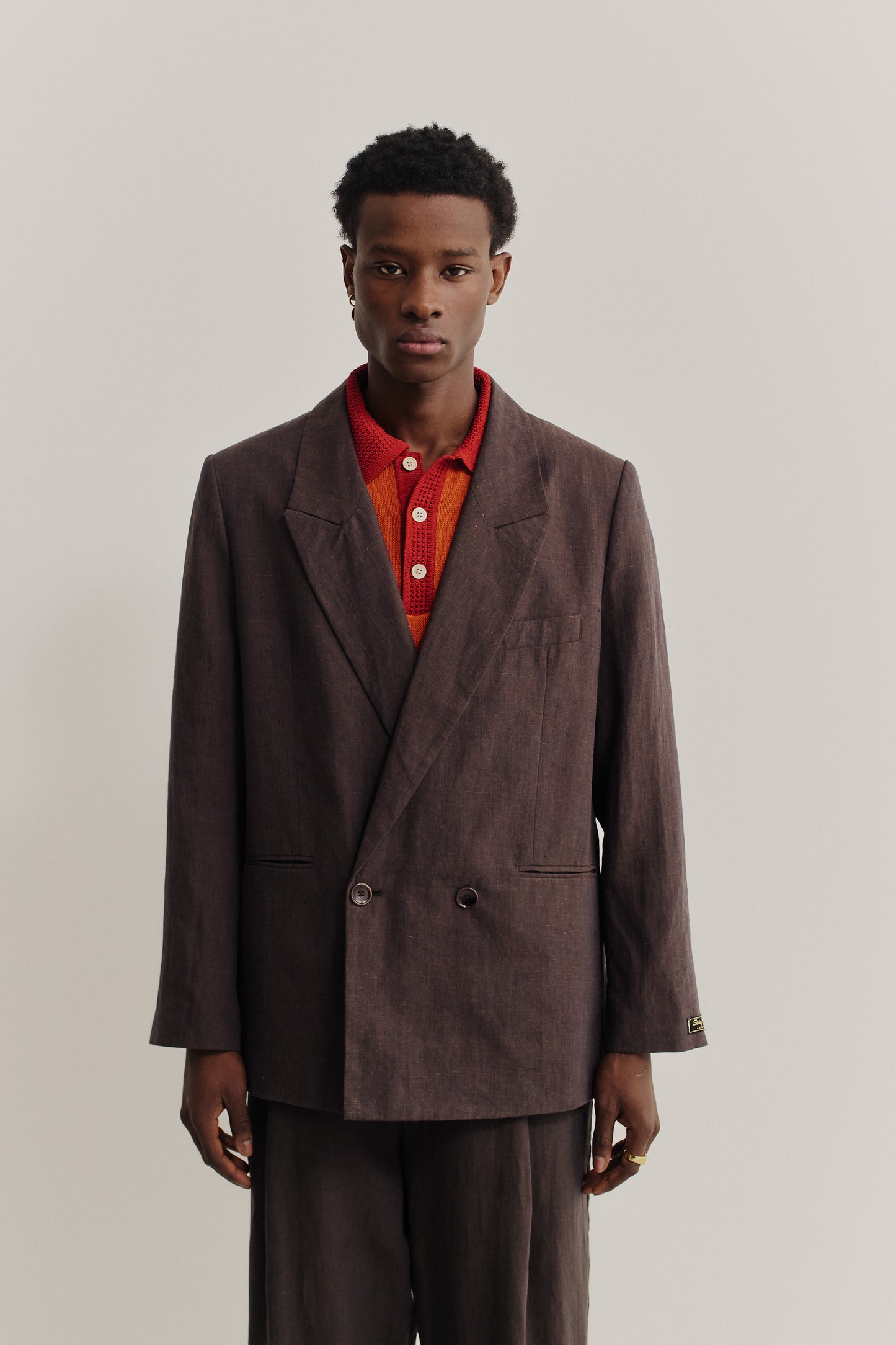 Men's tailoring, relaxed double-breasted linen blazer in burnt umber with double back slits.