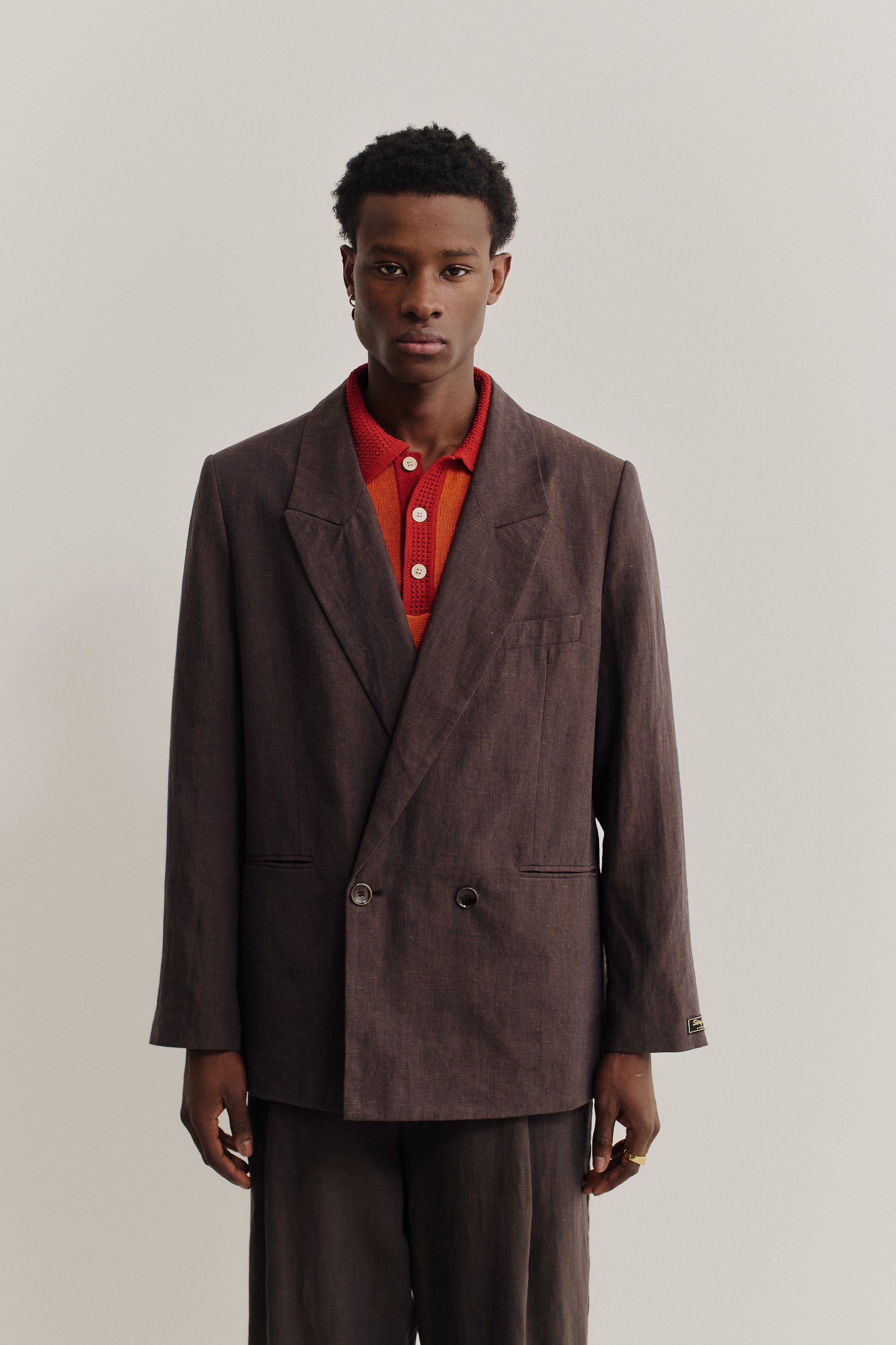 Men's tailoring, relaxed double-breasted linen blazer in burnt umber with double back slits.
