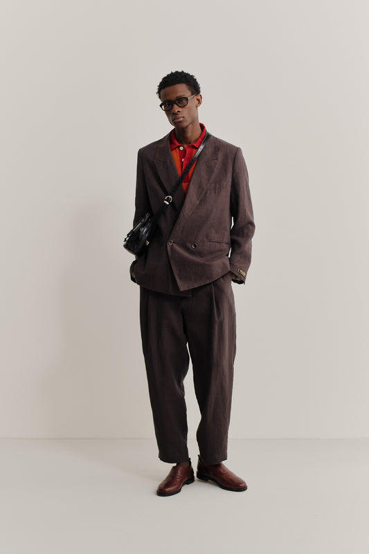 Men's tailoring, linen, burnt umber, relaxed double-buttoned blazer and trousers with red polo.
