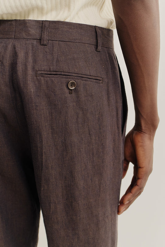 Men's long-pants, 100% linen with natural slubs, dark brown, featuring a welt back pocket with button.