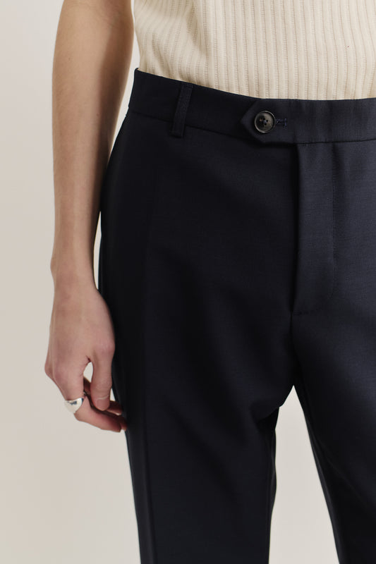 Men's long-pants, virgin wool, dark navy, relaxed tailored fit with visible front button and pleat.