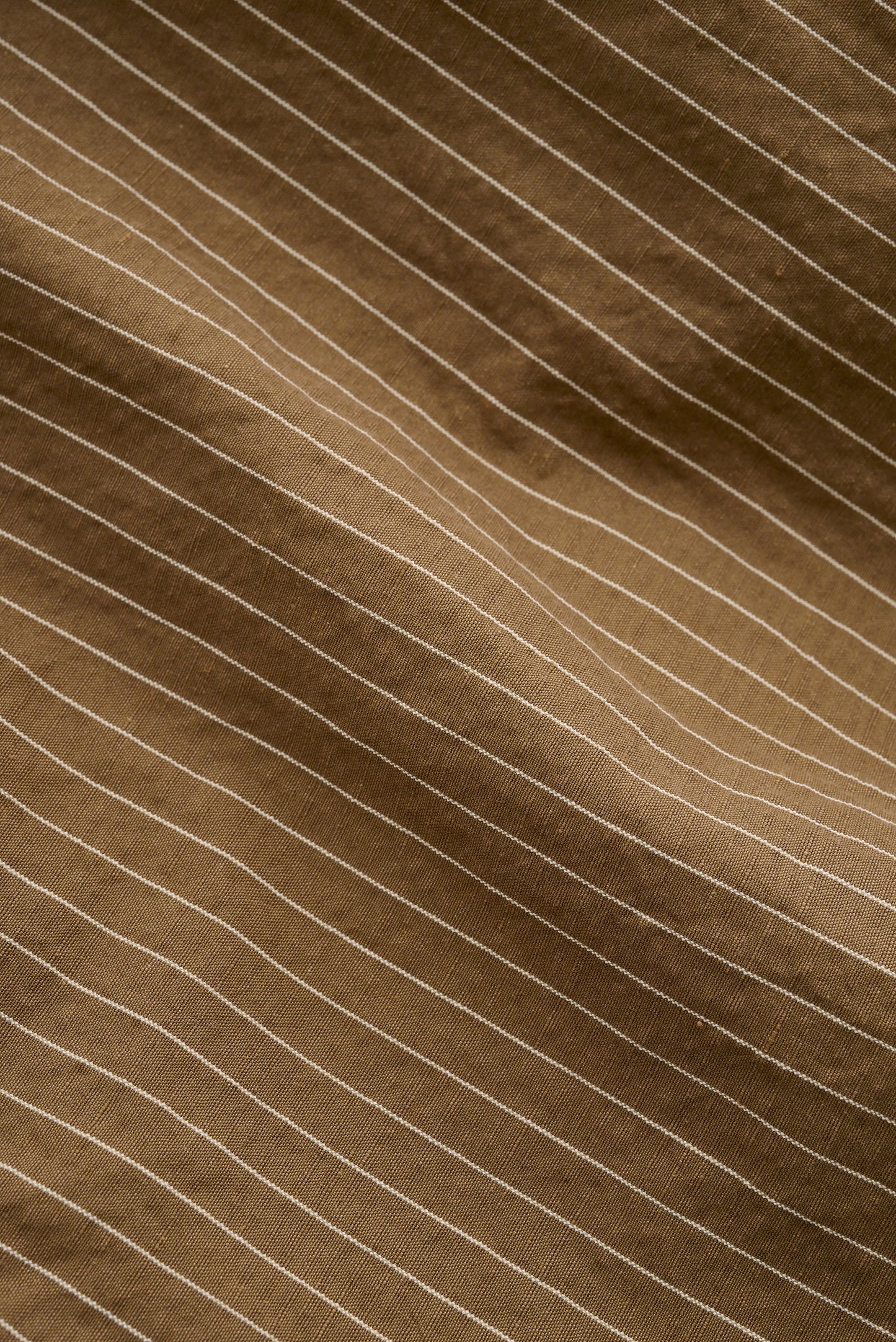 Men's shorts, cotton-linen seersucker with fine white pinstripes on a brown background.