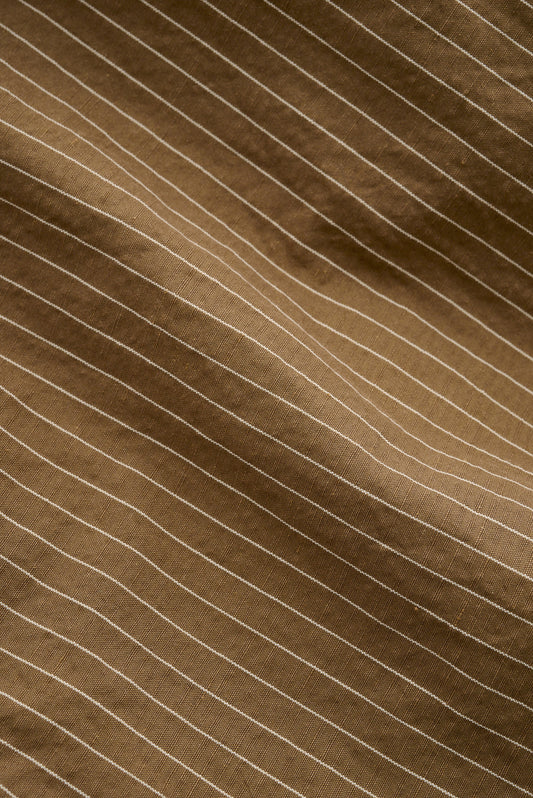 Men's shorts, cotton-linen seersucker with fine white pinstripes on a brown background.