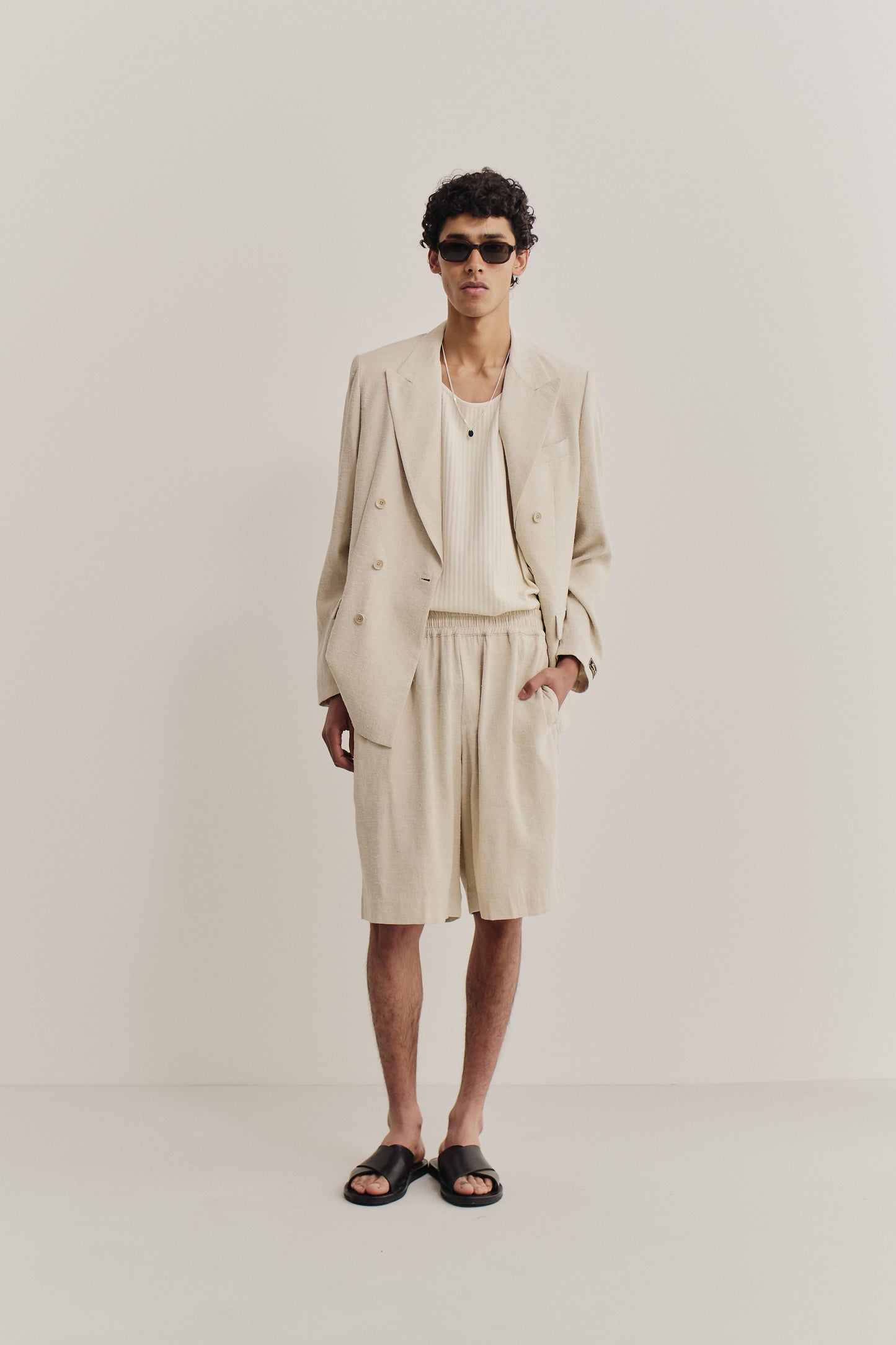 Men's tailoring and shorts, linen-silk blend, undyed natural beige, relaxed fit.