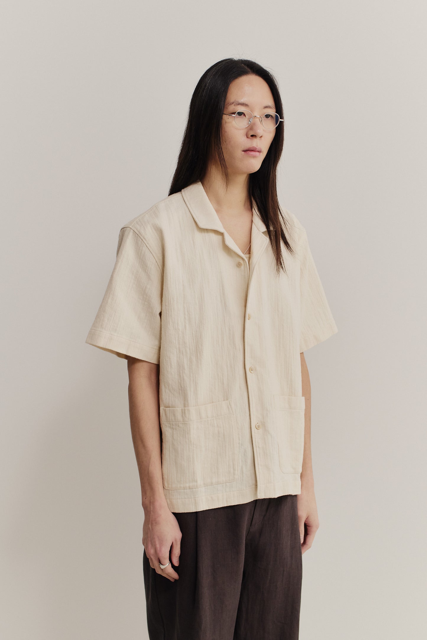 Men's short-sleeved shirt, recycled cotton mix, textured weave, natural slubbed effect, light beige.