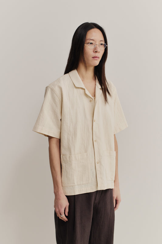 Men's short-sleeved shirt, recycled cotton mix, textured weave, natural slubbed effect, light beige.