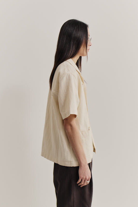 Men's short-sleeved shirt, recycled cotton mix, textured weave, natural slubbed effect, plain base, light beige.