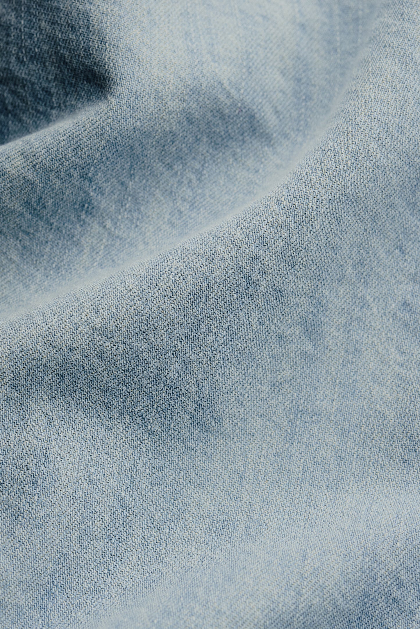 Men's short-sleeved shirt, light blue organic cotton and silk denim with vintage-inspired texture.