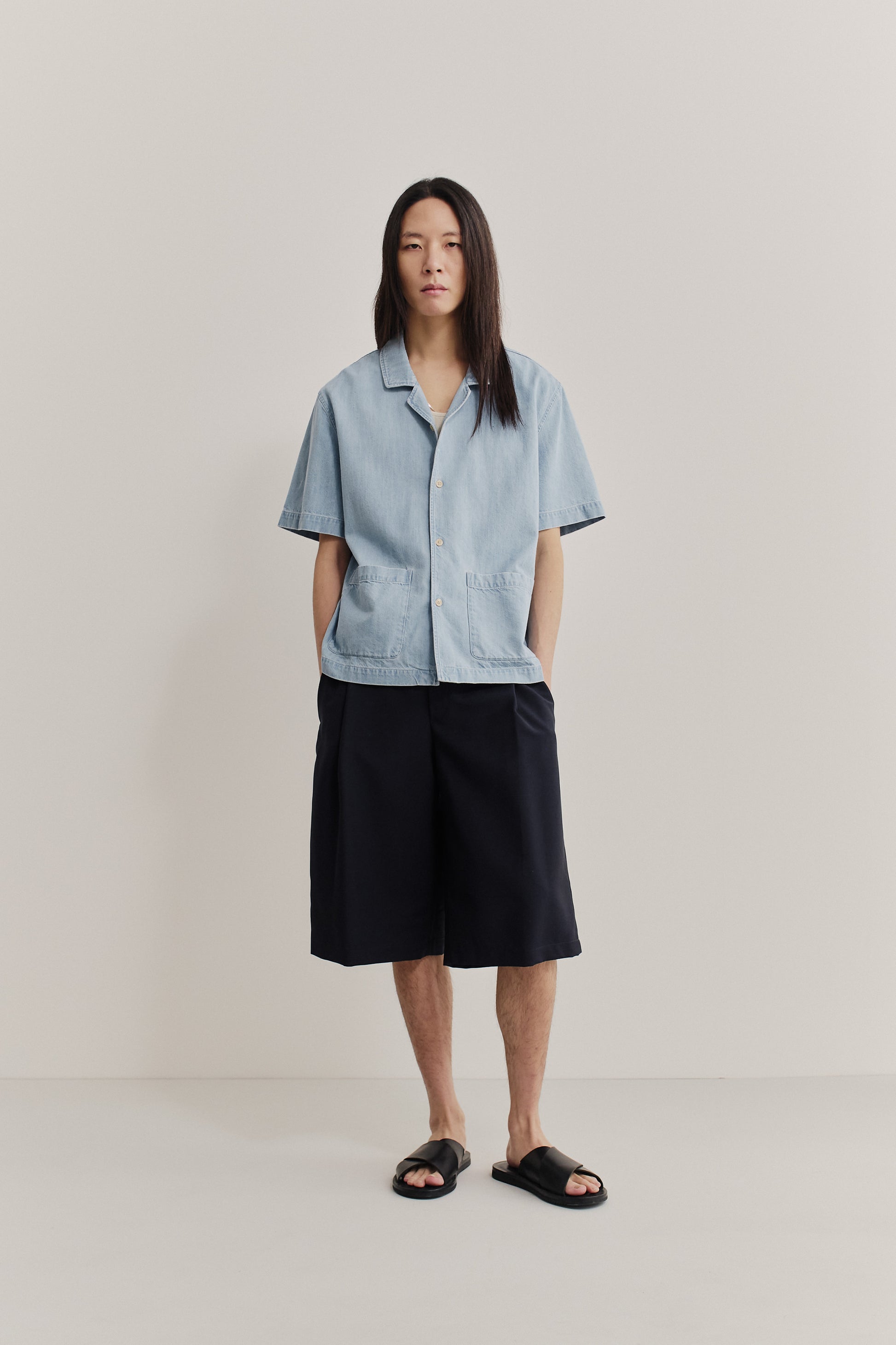 Men's short-sleeved shirt, light blue organic cotton-silk denim, rounded spread collar, double patch pockets.