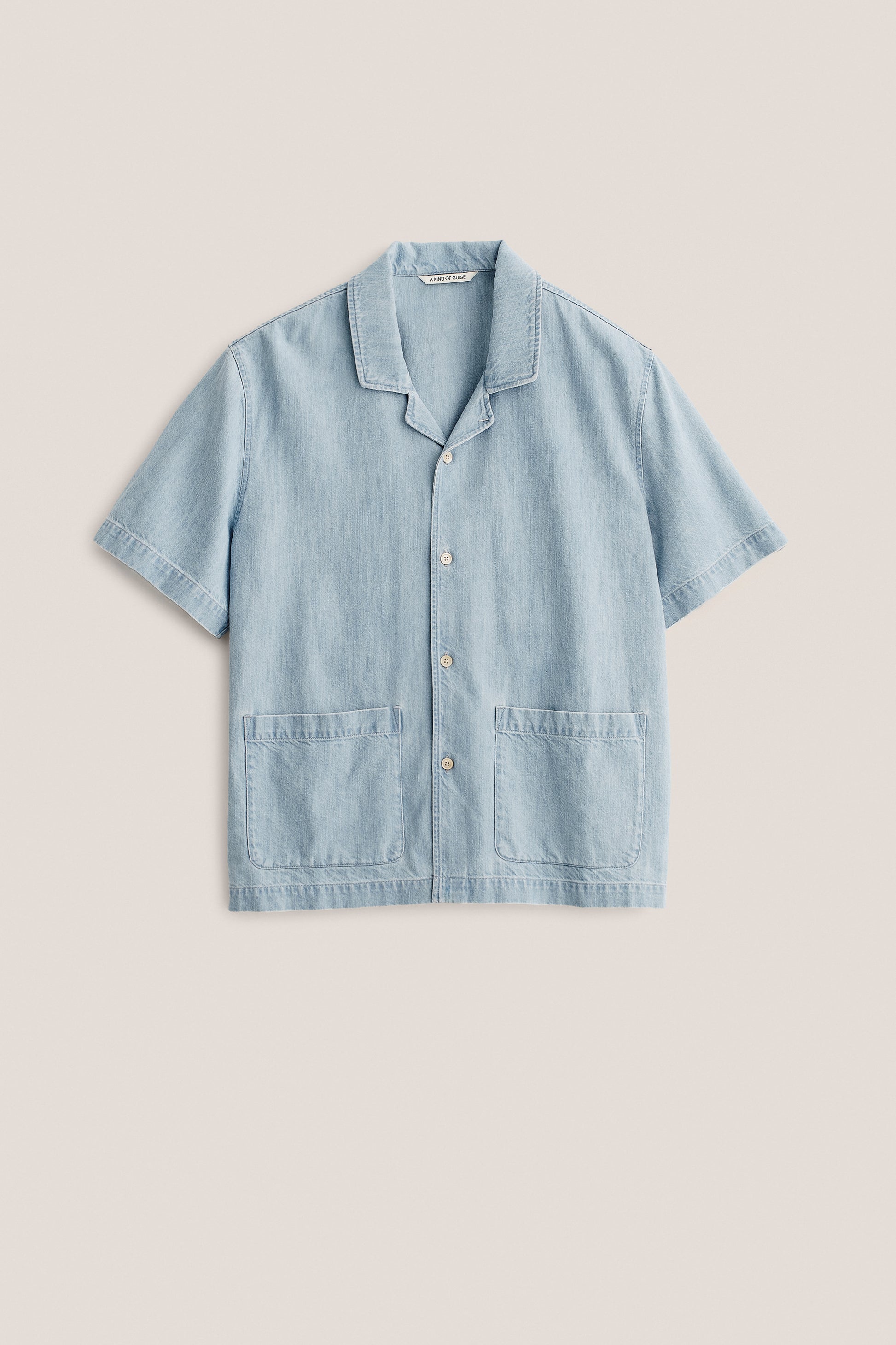 Men's short-sleeved shirt, light blue organic cotton-silk denim, rounded spread collar, double patch pockets.
