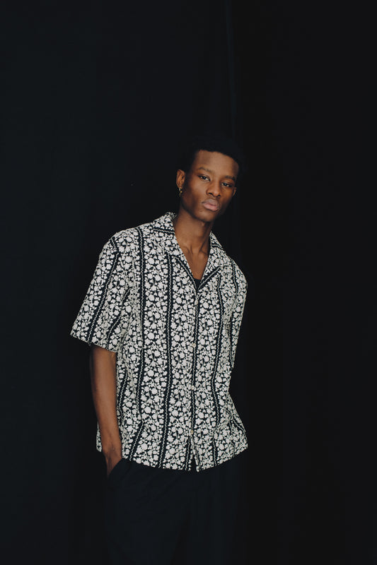Men's short-sleeved shirt, 100% cotton, black with white embroidered flower blocks, notched collar.