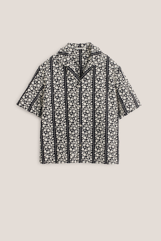 Men's short-sleeved shirt, 100% cotton, black with embroidered white flower blocks and wavy lines.